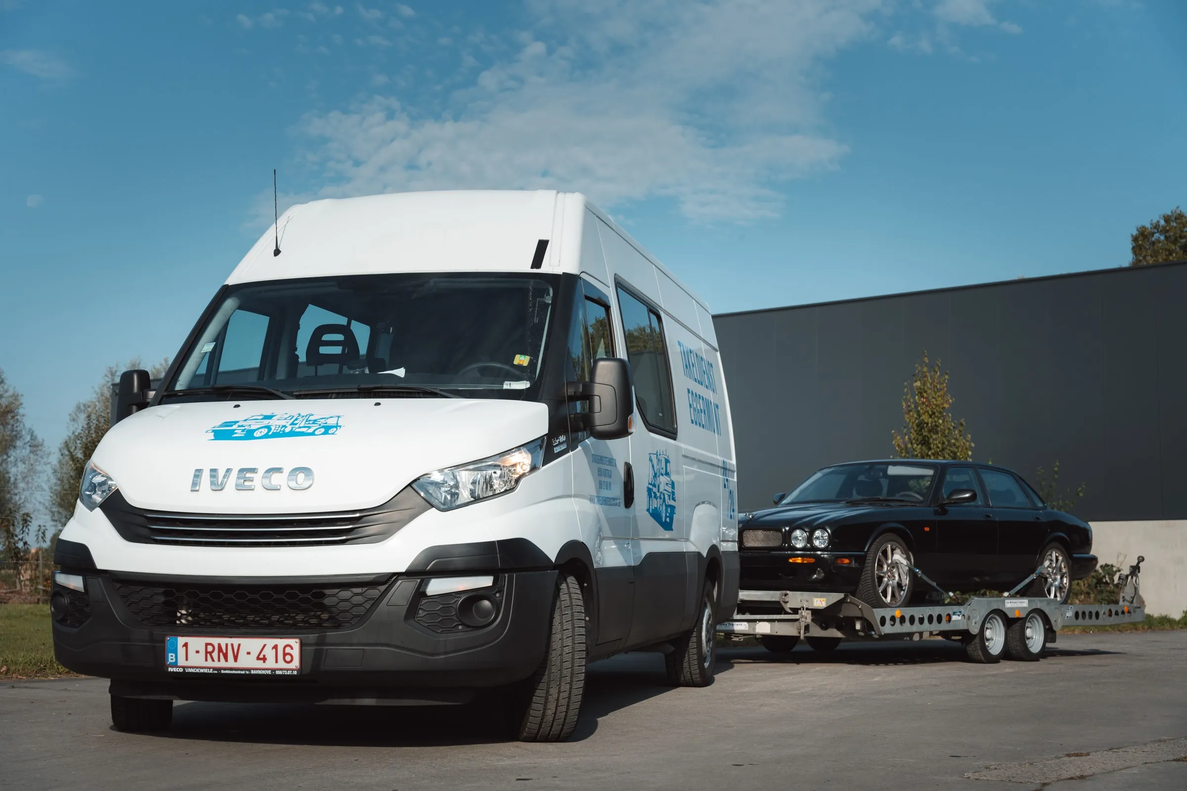 De bestelwagen met aanhangwagen van voren